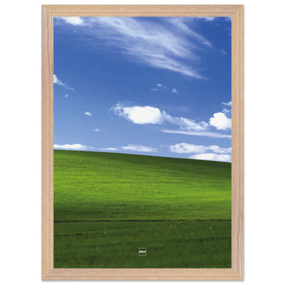 Réplique avec encadrement du fond d'écran Bliss avec une colline verdoyante, un ciel bleu et des nuages blancs.